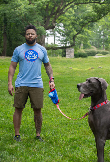 A man and his dog are playing frisbee in the park.