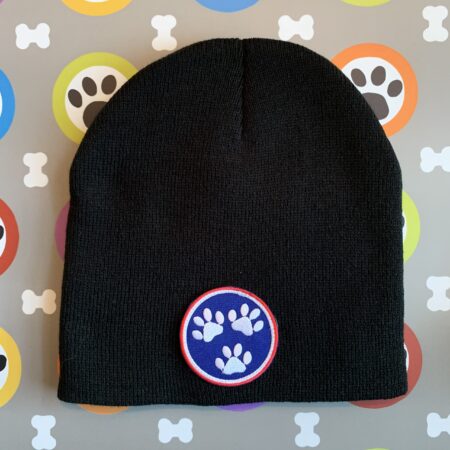 A black beanie with a paw print patch on it.