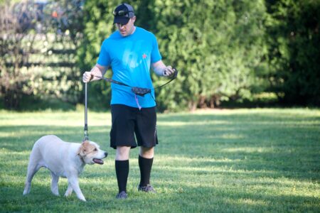 A man walking his dog on a leash.