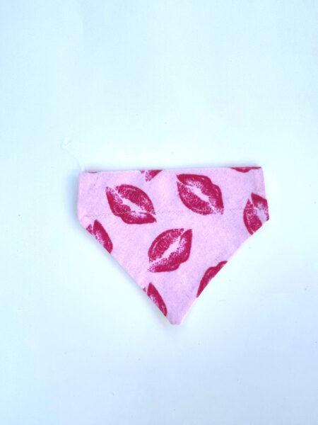 A pink bandana with red lips on it.