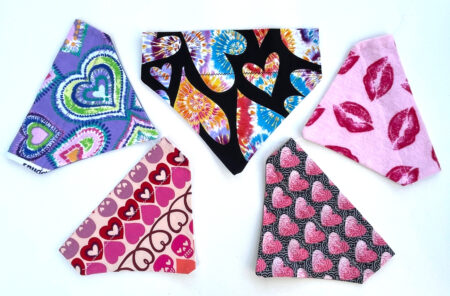 A group of hearts and lips bandanas on top of each other.